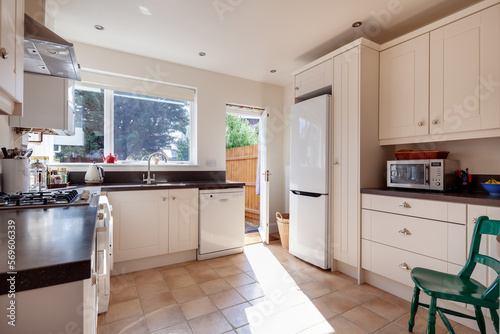 Fitted kitchen with freestanding refrigerator