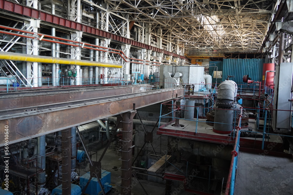 Almaty, Kazakhstan - 10.07.2022 : Pipes, valves and pressure sensors in the generator room at the heating plant.