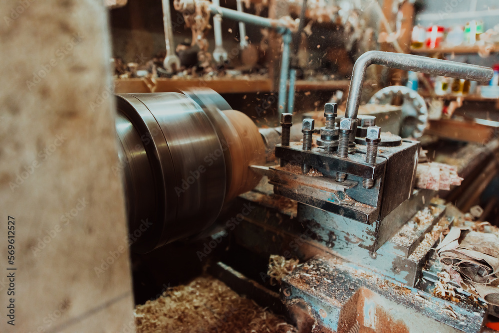 Close-up photo of a lathe working on wood. Mechanical processing of wood