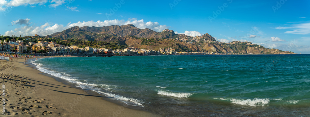View of Taormina and Castelmola viewed from beach at Giardini Naxos, Sicily, Italy, Mediterranean, Europe