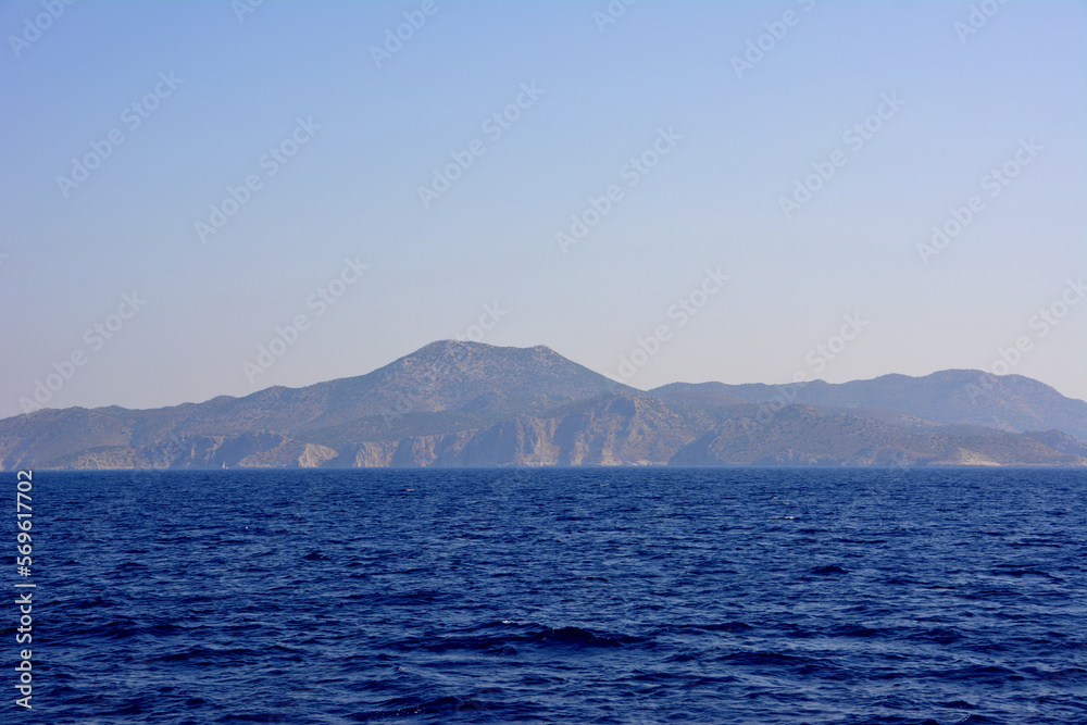 mediterranean sea with dark blue water and waves and coastline with hills on background mediterranean sea with dark blue water and waves and coastline with hills on background