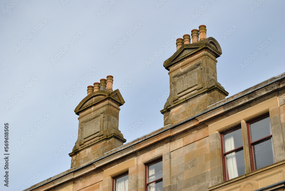 Close Up of Classical Style Chimney Stacks on Stone Tenement Building 
