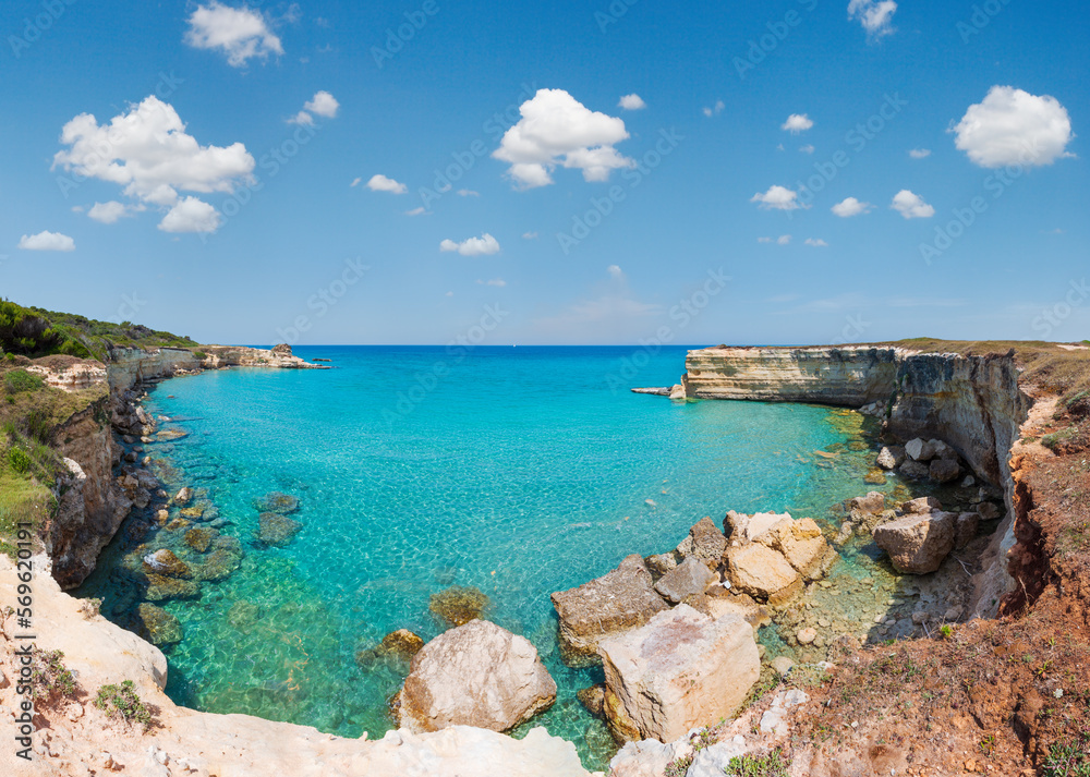 Fototapeta premium Picturesque seascape with white rocky cliffs, sea bay, islets and faraglioni at beach Spiaggia della Punticeddha, Salento Adriatic sea coast, Puglia, Italy