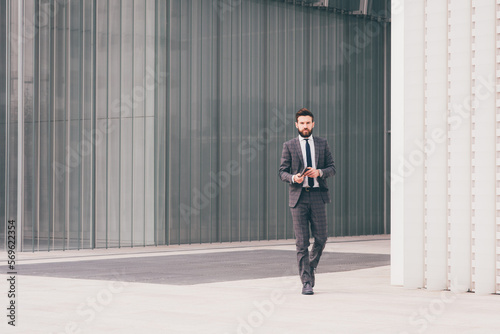 Confident and professional elegant bearded businessman walking outdoor strong and trusty © Eugenio Marongiu
