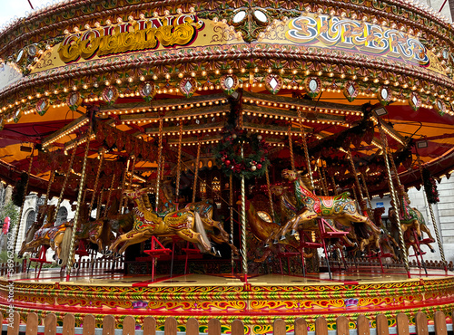 Colourful Carousel, with horses, ornaments, and lights, in the centre of, Leeds, Yorkshire, UK