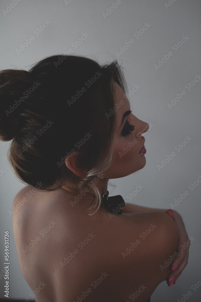Portrait of a beautiful girl with smokey eye makeup and juicy lustre on her sown jacket lips/ The girl has an evening professional hairstyle made of hair. The woman is wearing hanging earrings Portrait of a beautiful girl with smokey eye makeup and juicy lustre on her sown jacket lips/ The girl has an evening professional hairstyle made of hair. The woman is wearing hanging earrings