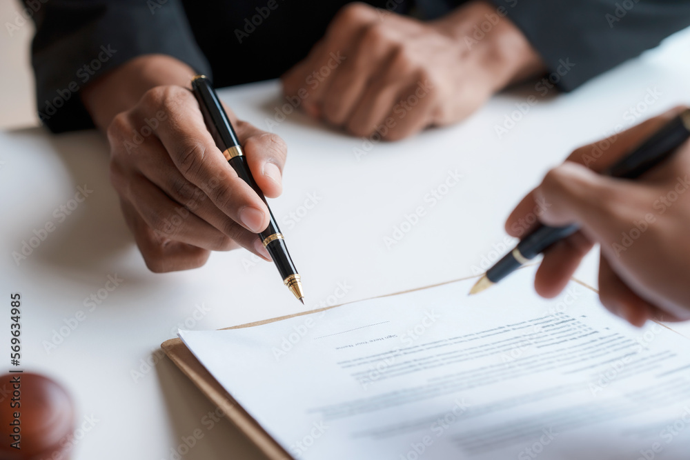 Lawyer and client sign variou financial legal contract to mediate with the legal execution department and make appointment for client to mediate debt settlement agreement. - obrazy, fototapety, plakaty 