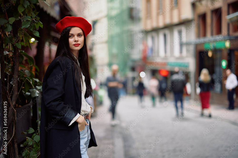 Woman fashion model walks on the street in the city center among the crowd in a jacket and red beret and jeans, cinematic french fashion style clothing, travel to istanbul
