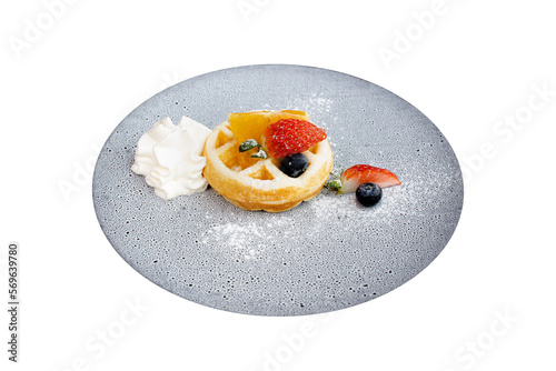 Obraz na plátně Delectable Waffle Delight: A visually stunning waffle creation adorned with an array of fresh fruits and a delicate dollop of whipped cream, presented on an elegant plate