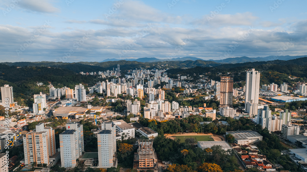 aerial image of downtown Blumenau, with Itajaí Açú River, Santa Catarina, southern Brazil, buildings, main streets, vegetation and sunny day
