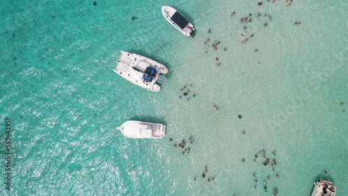 Aerial view of tourists swimming yachts and tour boats in sting ray city in Cayman Islands in shallow turquoise water photo