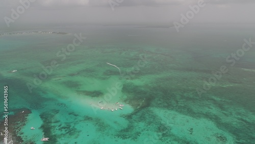 High aerial view of yachts and tour boats in sting ray city in Cayman Islands in shallow turquoise water photo