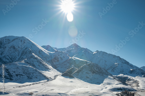 Canvastavla Panoramic view of snowcapped mountains illuminated by the sun