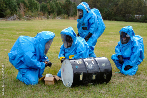 Level 5 HAZMAT Specialist Responders train during a biohazard spill simulation exercise. They seal a leaking drum in Level A positive pressure personnel suits using self-contained breathing apparatus.