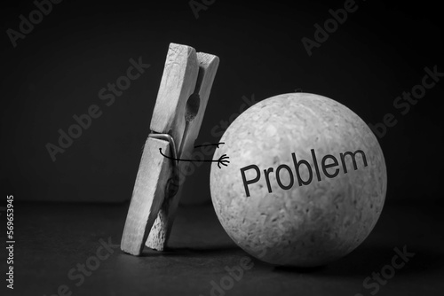 creative problem-solving concept. The clothespin pushes a large ball with the inscription 