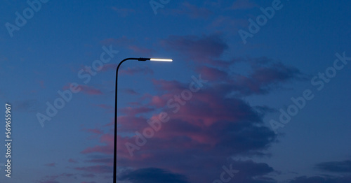 one lantern burns against the backdrop of sunset. The sky is blue-pink, dramatic. mystical picture