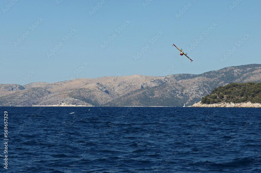 Fototapeta premium Fire fighting airplane in action, Hvar Island, Croatia
