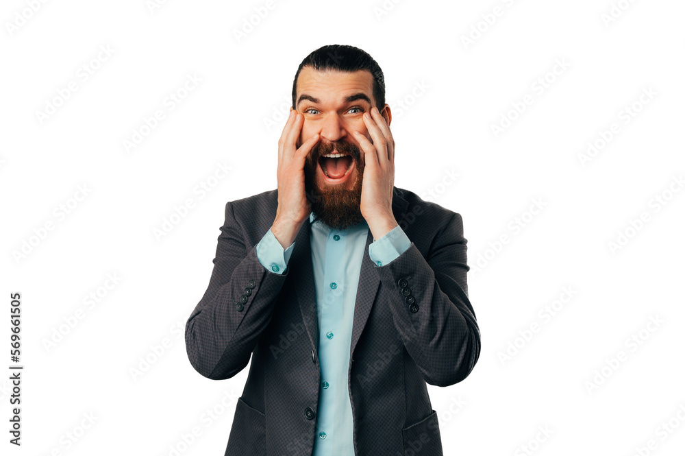 Ecstatic surprised bearded man is looking at the camera and touching his face over white background. Ecstatic surprised bearded man is looking at the camera and touching his face over white background.