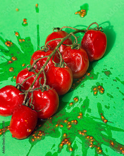 Smashed tomatoes of a green background