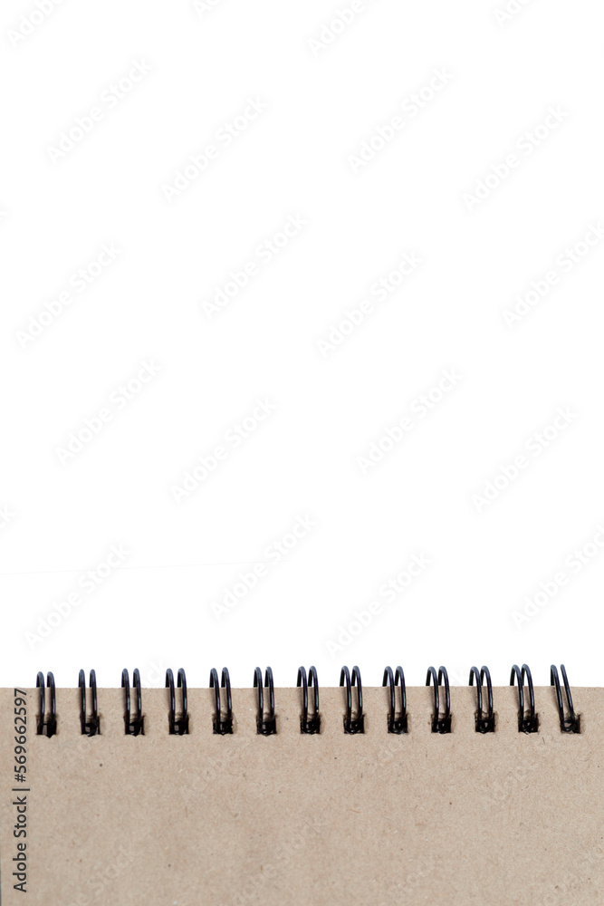 Craft notepad on springs with pages in natural beige color on an isolated on white background. Space for text. Vertical. Craft notepad on springs with pages in natural beige color on an isolated on white background. Space for text. Vertical.