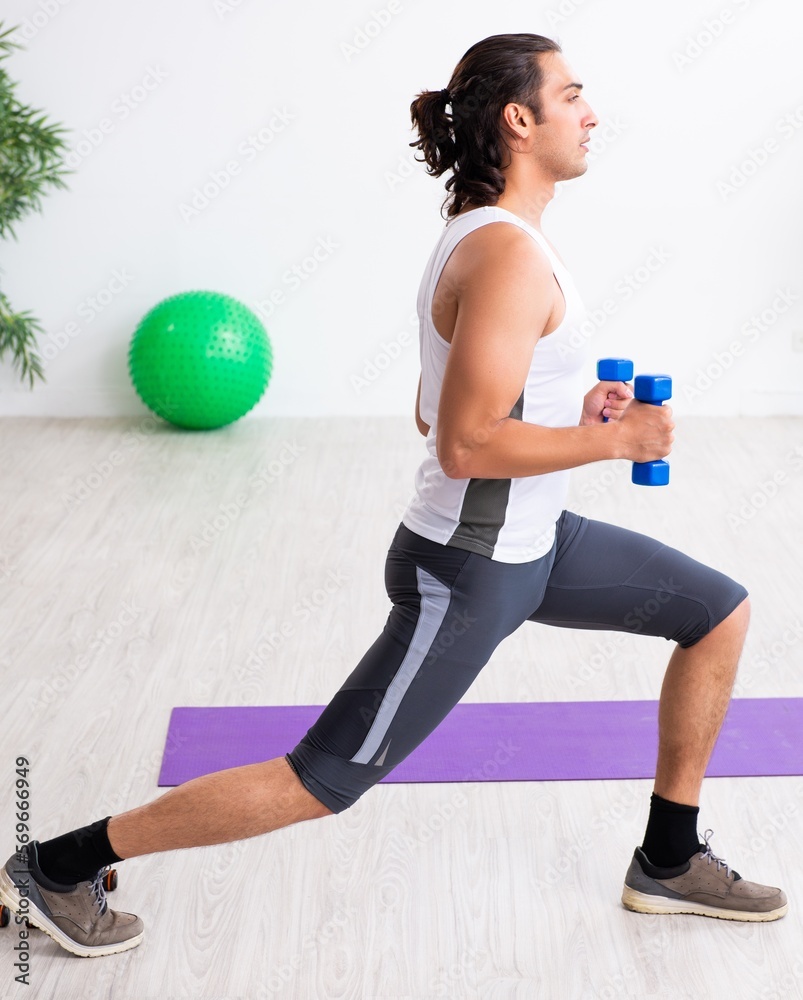 Young handsome man doing sport exercises indoors Young handsome man doing sport exercises indoors