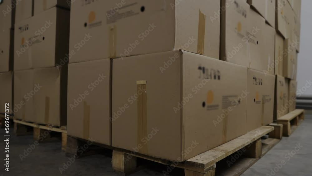 Manufactured product packaged into the big cardboard boxes at the factory. Keeping the product packages inside the factory storage room. Packages boxes filled with produced items at the factory. Manufactured product packaged into the big cardboard boxes at the factory. Keeping the product packages inside the factory storage room. Packages boxes filled with produced items at the factory.