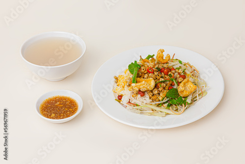 Com hen Hoi An, Vietnamese rice dish with baby basket clams rice, Vietnamese food isolated on white background; perspective view