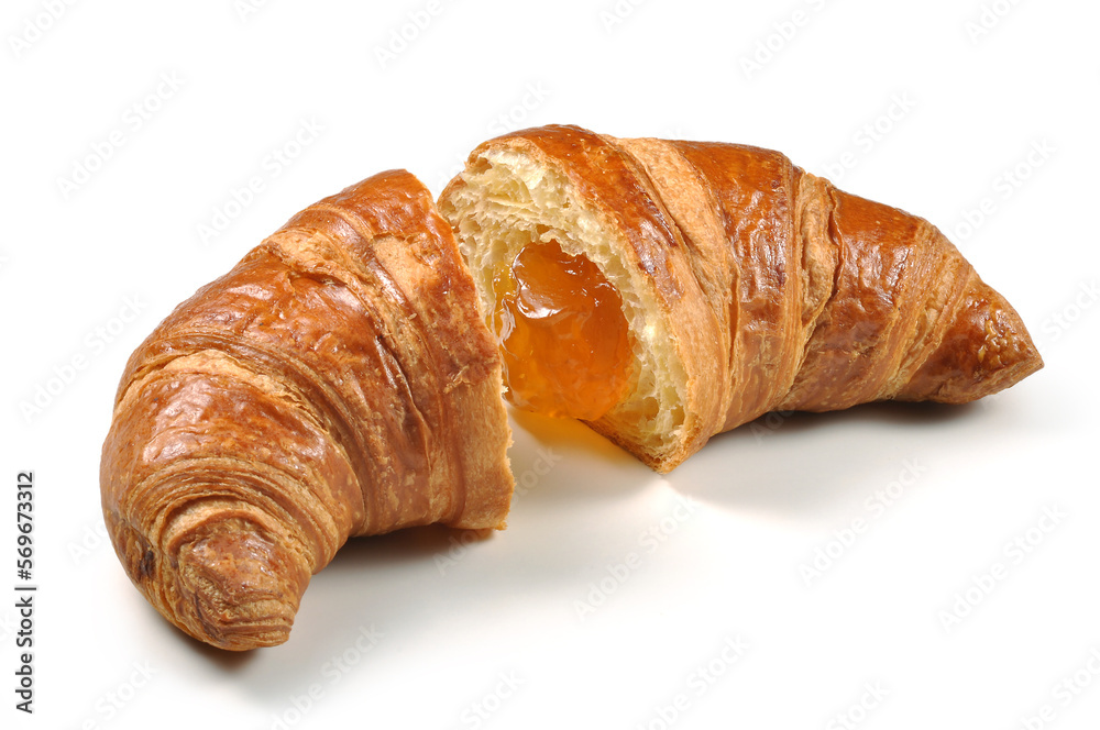 Croissant cut in half with apricot jam isolated on white background