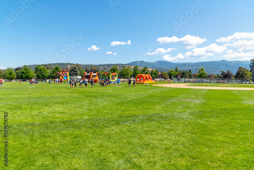 Families play at Pavilion Park during a summer festival and fair in the Spokane Washington suburb of Liberty Lake, Washington.	