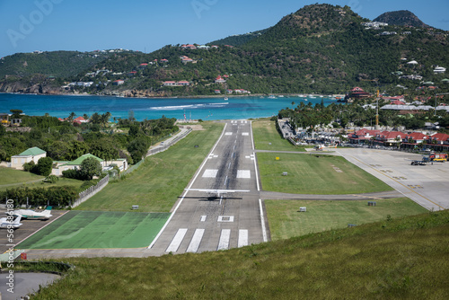 Aircraft landing on the runway at Rémy de Haenen Airport on the French Caribbean island of St Barth (Saint Barthelemy) © timsimages.uk