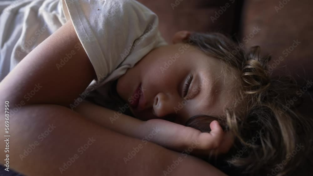 Small boy opening eye waking up from sleep. Child wakes up from slumber nap on couch Small boy opening eye waking up from sleep. Child wakes up from slumber nap on couch