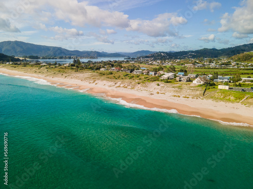 Aerial flight above Tairua ocean beach in New Zealand
