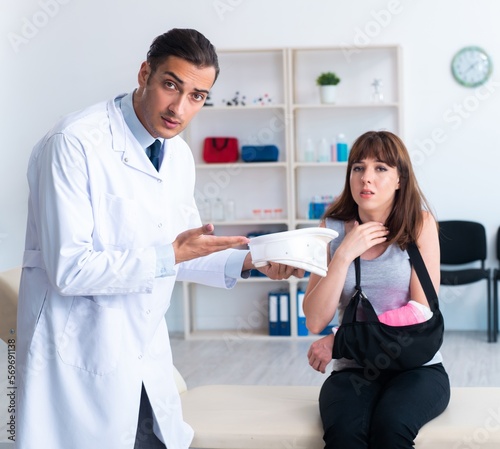Young woman visiting male doctor traumatologist
