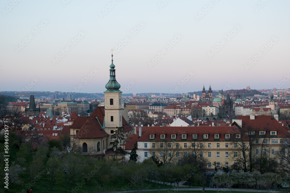 Old town of Prague. Czech Republic over river Vltava with Charles Bridge on skyline. Prague panorama landscape view with red roofs.