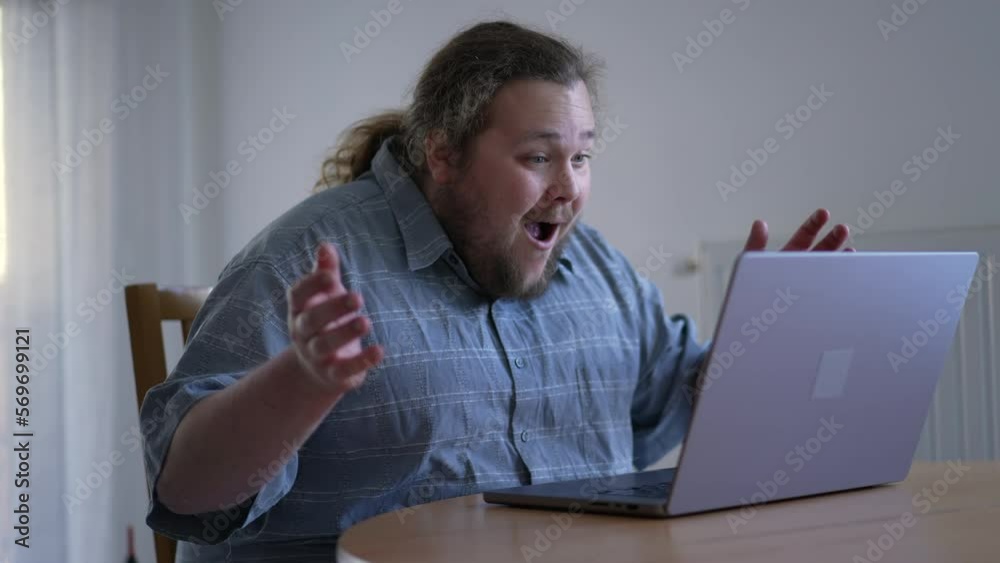 One excited chubby guy celebrating success in front of laptop computer. male person dancing in happiness. WOW emotion