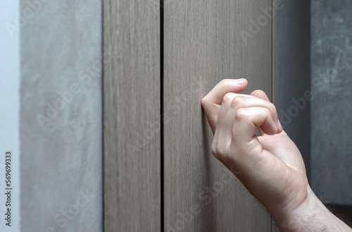 Knock on the village door. The young man knocks on the door. A man's finger knocks on the door. Visit to friends
