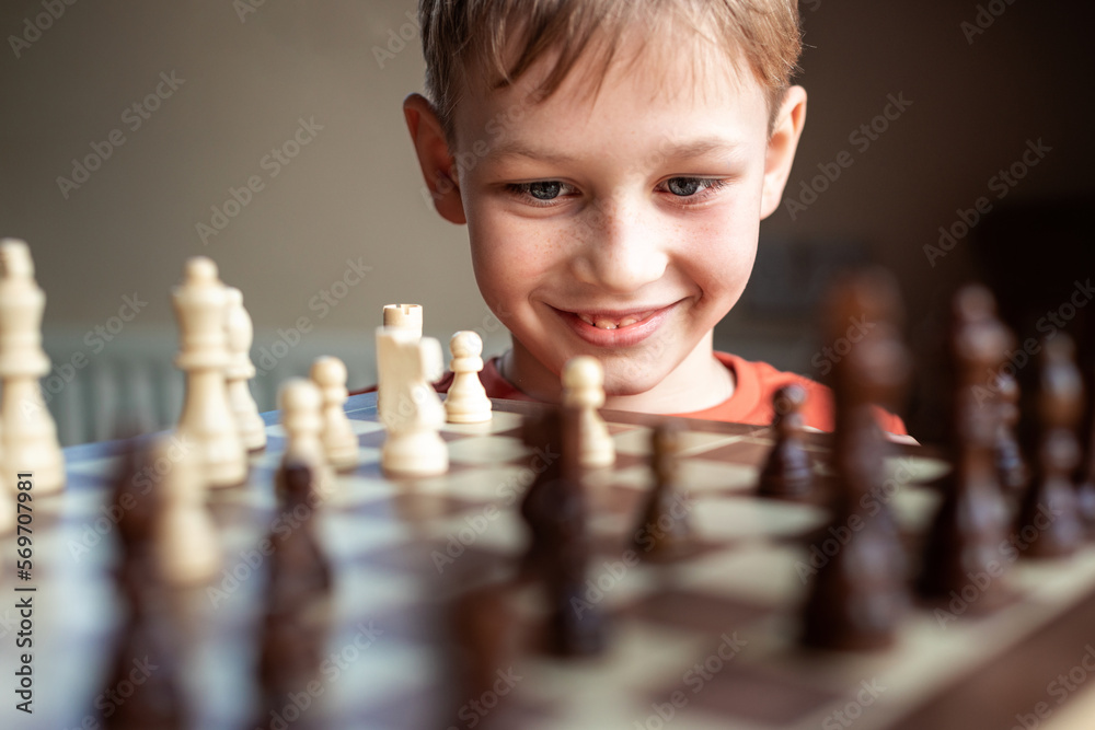 Young white child playing a game of chess on large chess board. Chess board  on table in front of school boy thinking of next move by Len44ik Vectors &  Illustrations with Unlimited