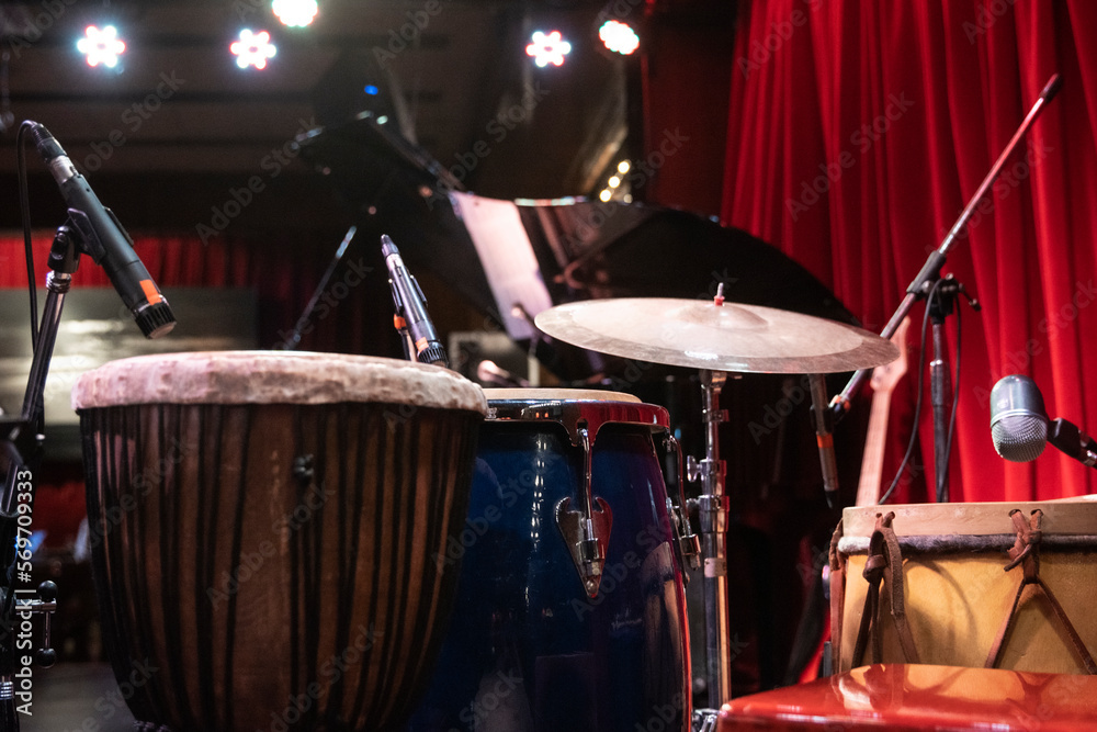 Drumming kit and professional sound set for a Jazz live concert at Latin festival in an intimate club. Copy space. Drumming kit and professional sound set for a Jazz live concert at Latin festival in an intimate club. Copy space.