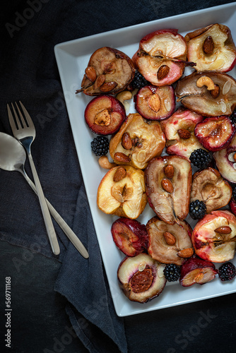 Baked apples, pears and plums with almonds, nuts and honey. Delicious and healthy dessert. Top view.