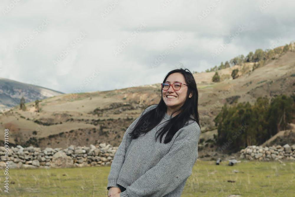 Portrait of woman enjoying her vacation in a mountain landscape in the Andes Mountains in South America. Concept of people, travel and vacation.