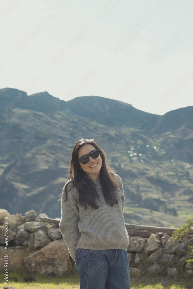 Portrait of a tourist woman enjoying her vacation in a mountain landscape in the Andes Mountains (South America). Concept professions, people, travel and vacations. Portrait of a tourist woman enjoying her vacation in a mountain landscape in the Andes Mountains (South America). Concept professions, people, travel and vacations.