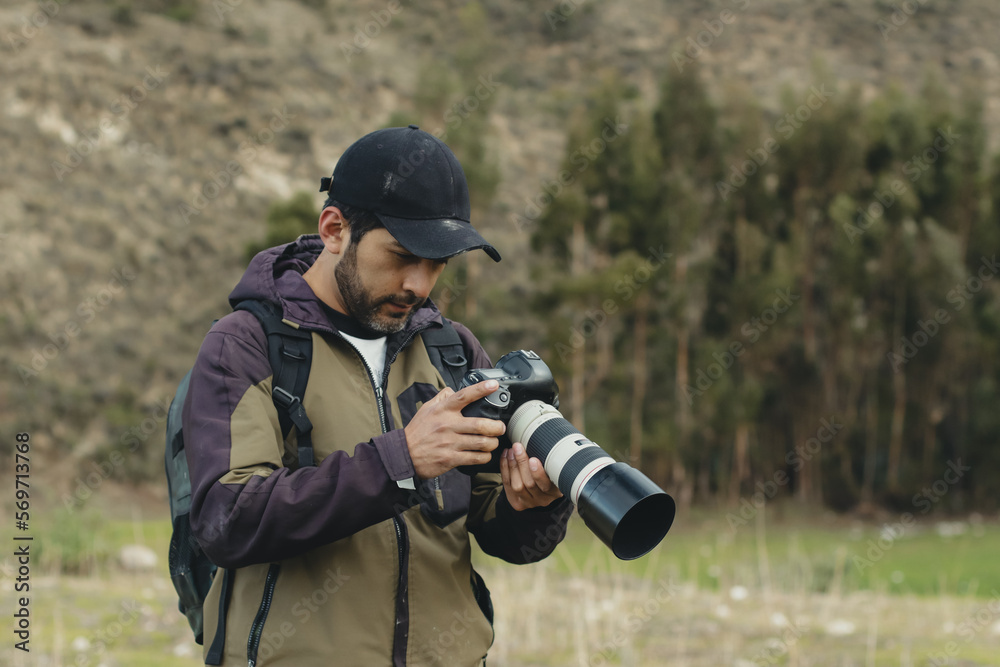 photographer smiling with his camera in his hand in a part of the Andes mountain range in Peru. Concept professions, people, travels and vacations.
photographer smiling with his camera in his hand in a part of the Andes mountain range in Peru. Concept professions, people, travels and vacations.