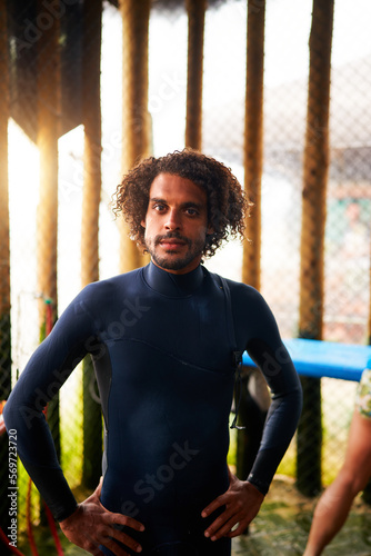 Billede på lærred portrait young mestizo brazilian afro handsome surfer with surf suit indoors