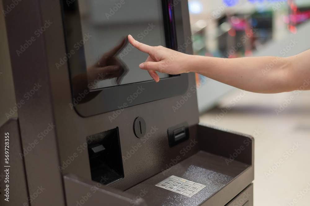 Faceless woman using touchscreen ATM. Faceless woman using touchscreen ATM.