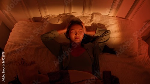 Depressed Asian woman cannot sleep insomnia suffering from insomnia lying in bed