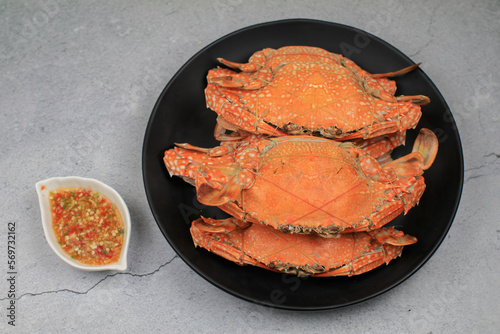 Steamed crab eating with spicy chili seafood dipping sauce. Thai style, seafood. Texture background with copy space for text