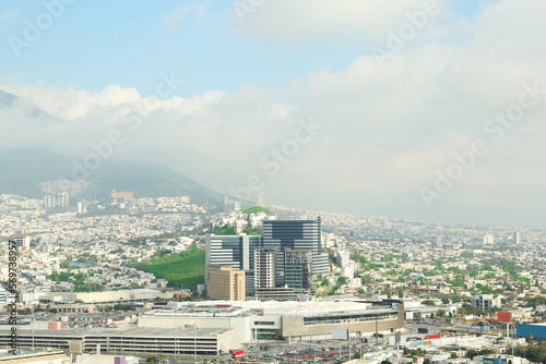 Picturesque view of cityscape with many buildings near mountain