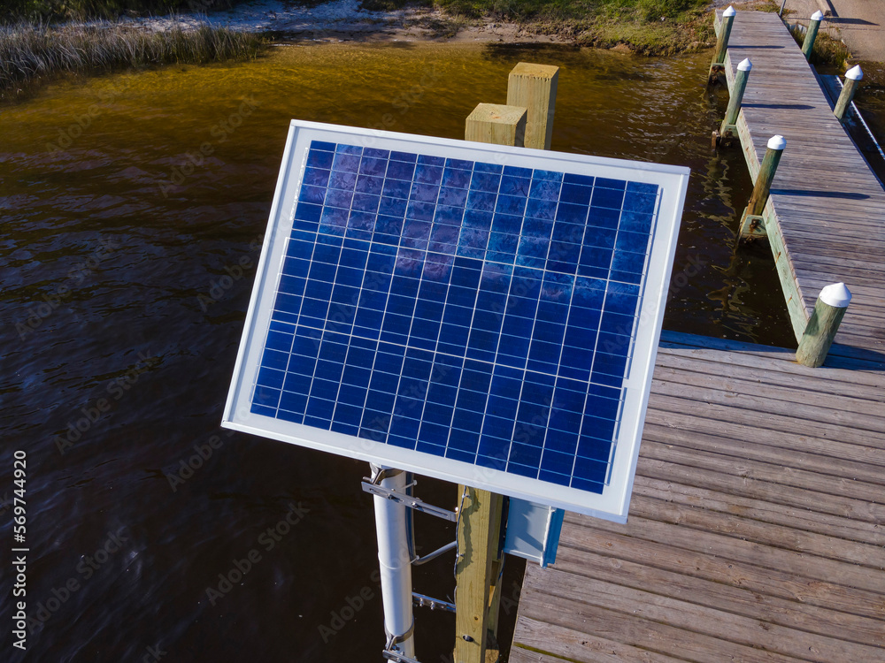 Square solar panel on a wooden dock at Navarre, Florida. Closeup of a