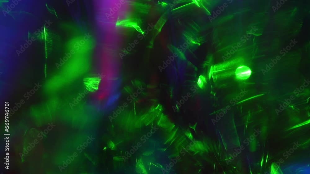 Light leaks effect background abstract animation. Green and neon blue lights sparkle through shiny crystal and prism. Lens light leaks flashing