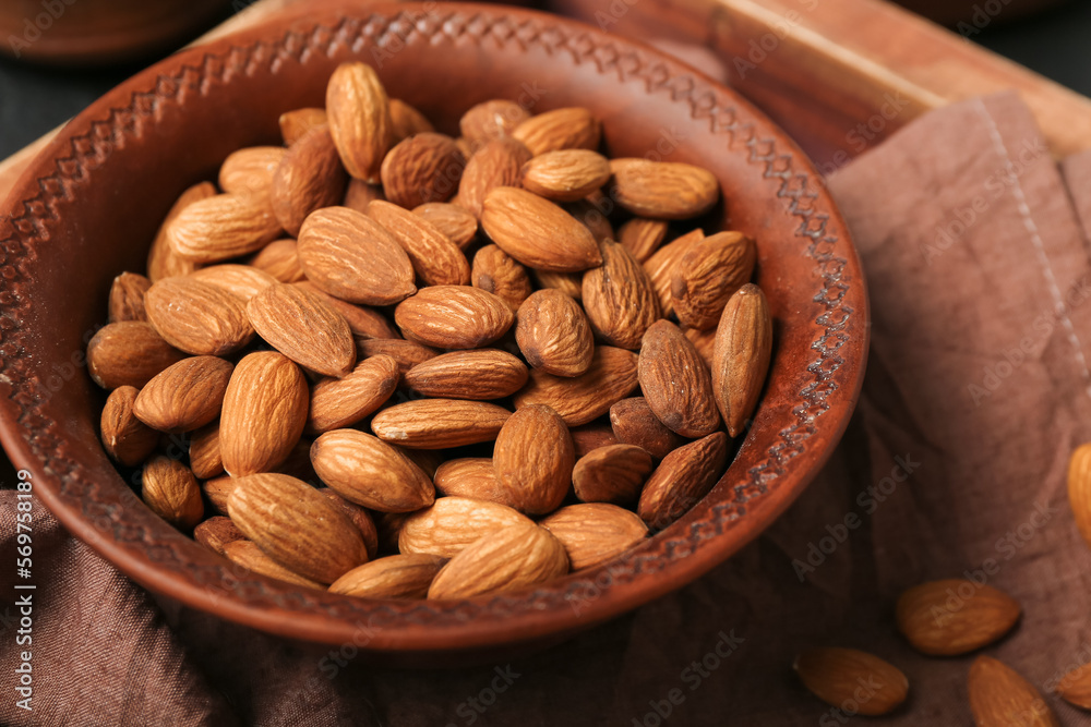 Plate of almond nuts on table, closeup Plate of almond nuts on table, closeup